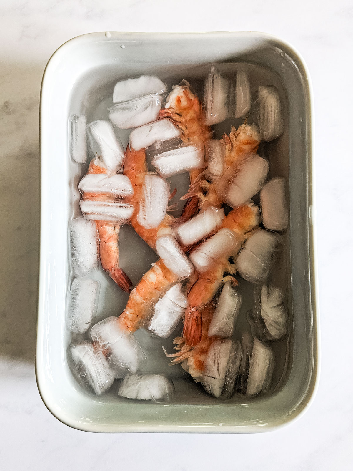 Cooking the shrimp by boiling in a large pan of salty water for 1 minute .