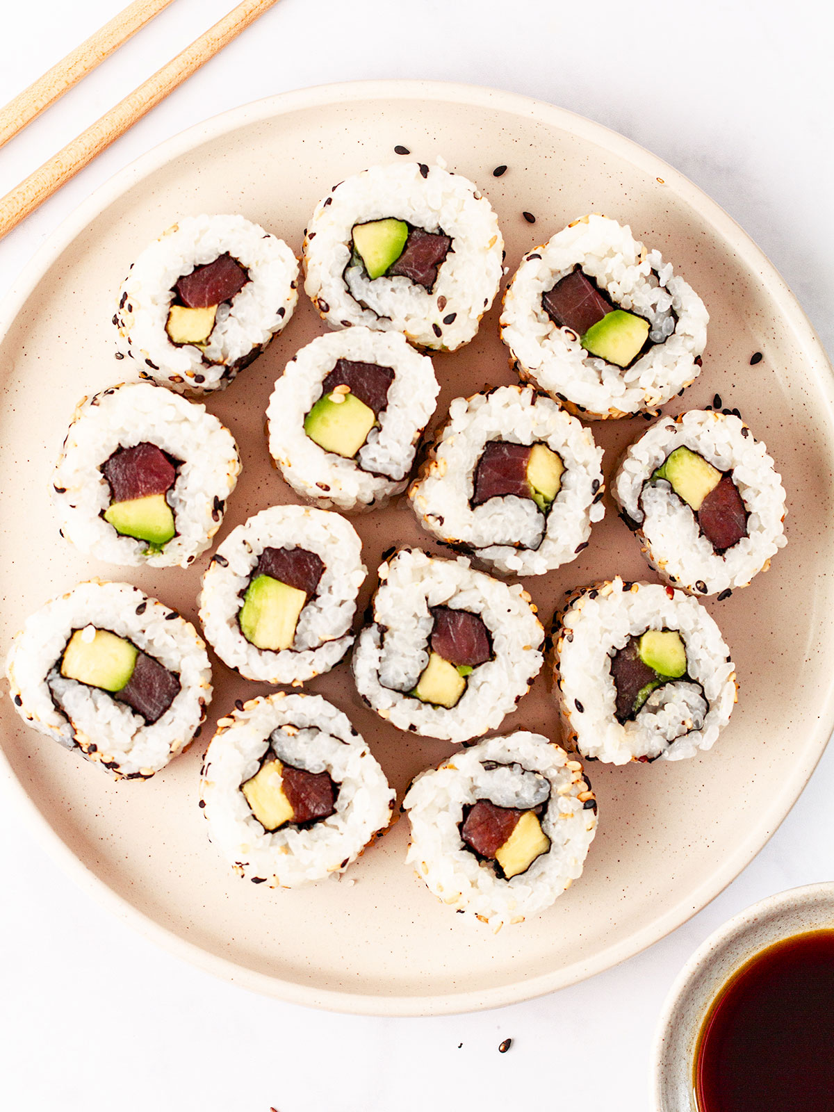 tuna avocado rolls on a white plate