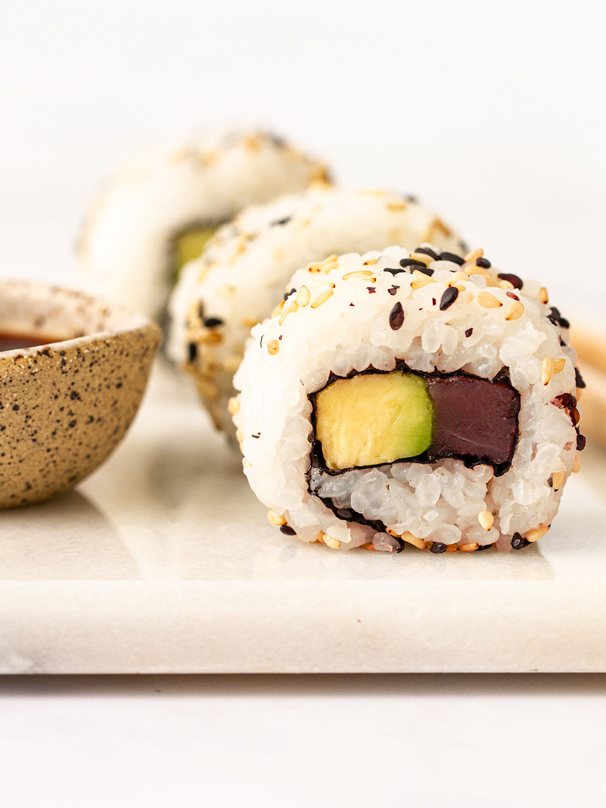 Tuna rolls on a white board.