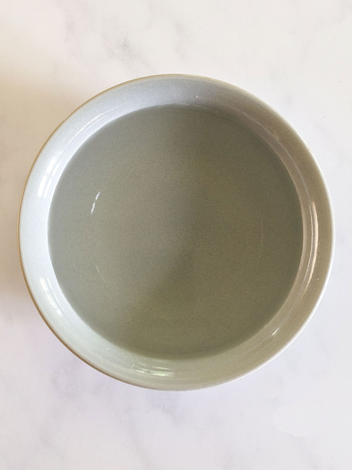 A blue bowl of hand water.